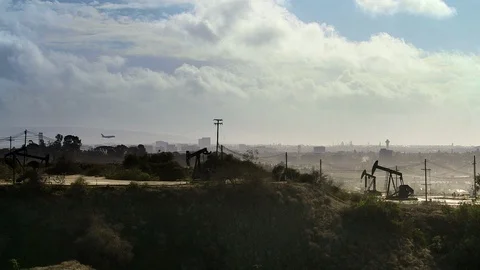 Oil fields. and power lines. Plain on final approach, Stock Footage 112783749