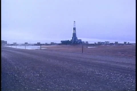 Oil fields, rig on horizon, gray and bleak, Deadhorse, Prudhoe Bay, Alaska Stock Footage