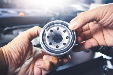 Oil filter in the mechanic hand for engine oil system maintenance 写真素材
