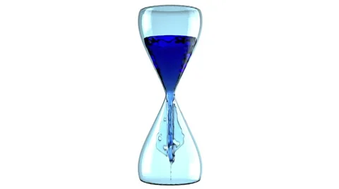 The oil flows in the hourglass Stock Footage 58580499