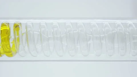Oil flows in a spiral into the flask.	 Video stock 144011875