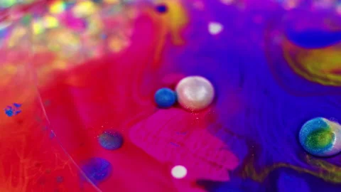 Oil fluid flow glitter ink water blue pink bubbles Video stock 260794666