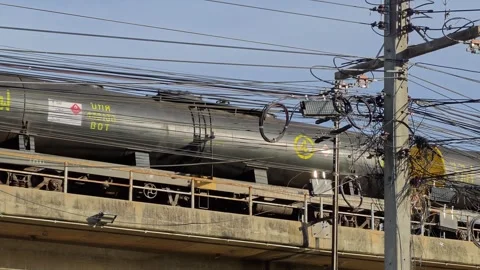 Oil freight train crossing an elevated railway bridge traveling from 動画素材 339098107