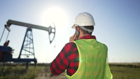 Oil industry. Engineer worker makes notes on operation of an oil pump. The Video stock 204841324