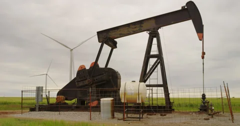 Oil lifting pumpjack and wind farm at work in the Oklahoma panhandle. Stock Footage 231018722