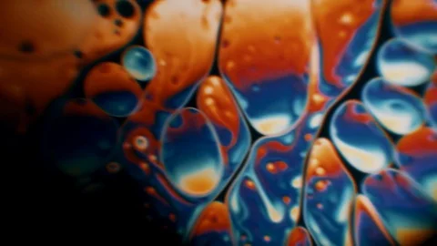 Oil molecules are moving by a microscope. Stock Footage