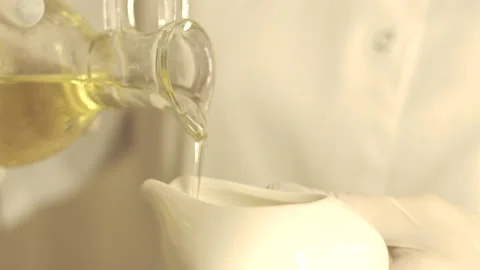 Oil or liquid is poured into a white bowl Video stock 145475083