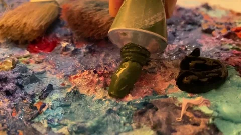 Oil paint drips onto the palette Stock Footage 149684867