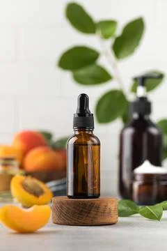 Oil with peach kernel extract in a brown glass pipette. Natural cosmetic. Stock-Fotos