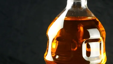 Oil in plastic bottle on black background Stock Footage 87221276