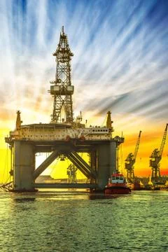 Oil platform in sunset time Stock Photos
