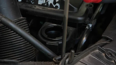The oil is poured into the motor Stock Footage 76864859