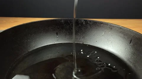 Oil is poured into the pan Stock Footage 233631394