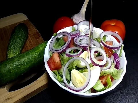 Oil is poured into a plate with salad Stock Footage