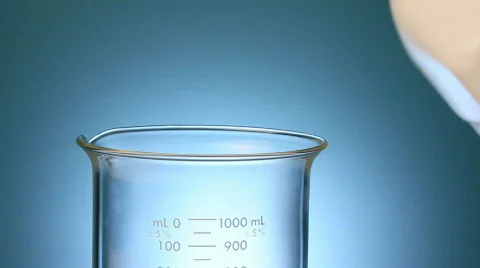 Oil pouring into a beaker Stock Footage 842826
