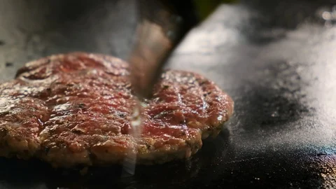 Oil is pouring on a cutlet. 스톡 동영상 120893104