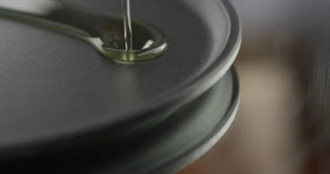 Oil pouring on a plate Stock Footage 199022863