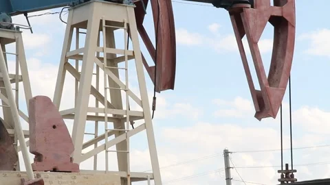 Oil pump close up on a background of blue sky with clouds on a summer day Stock Footage 137506698