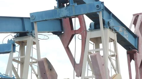 Oil pump close up on a background of blue sky with clouds on a summer day Stock Footage 137779257