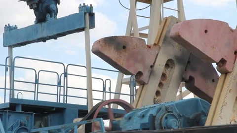 Oil pump close up on a background of blue sky with clouds on a summer day Stock Footage 137779299