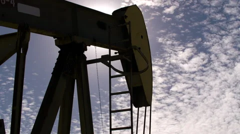 Oil Pump Close up Fracking back lit by the sun Stock Footage 68766461