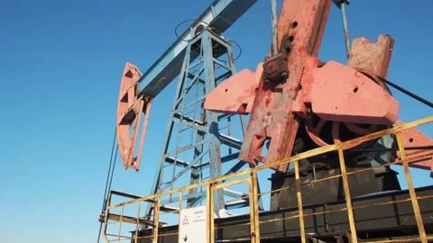 Oil pump drilling rig or rocking machine against the blue winter sky. Cold Stock Footage 156729103
