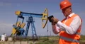 Oil Pump Field Engineer Man Using Tablet Planning Maintenance Service US Gas Rig 4k or 4k+ Resolution