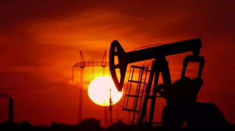 Oil pump in the field with sun setting in the back Stock Footage 41701765