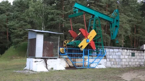 An oil pump jack. Belarus, Brest region, with a tripod, summer, day. Stock Footage 41235450