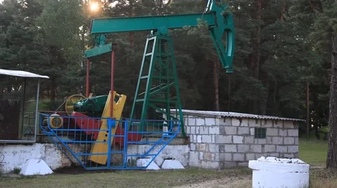 An oil pump jack. Belarus, Brest region, with a tripod, summer, day. Stock Footage 41235465