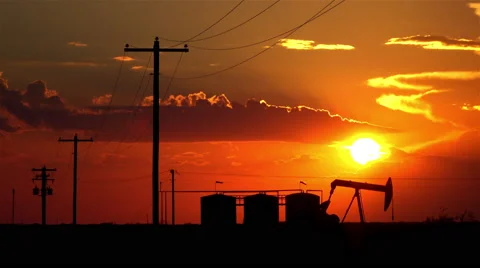 Oil pump jack containers and electrical wiring at amazing sunset Stock Footage 62222617