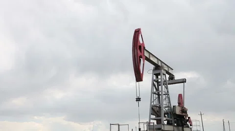 The oil pump is pumping oil. Cloudy sky. Stock Footage 63136495