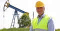 Oil Pump Rig Industrial Area Engineer Looking Camera Man Portrait Worker Smile 4k or 4k+ Resolution