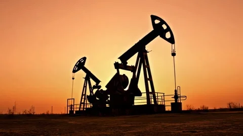 Oil pump silhouetted at the sunset Stock Footage 326751952