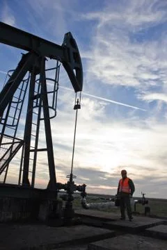 Oil pump at sunset Stock Photos