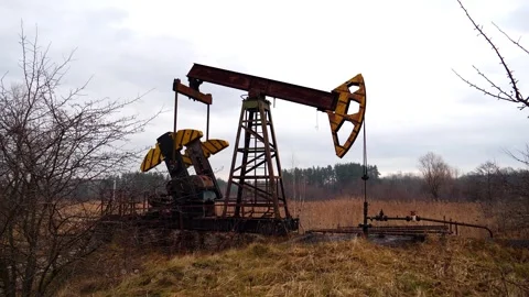 Oil pump work in small oil field Stock Footage 246437791