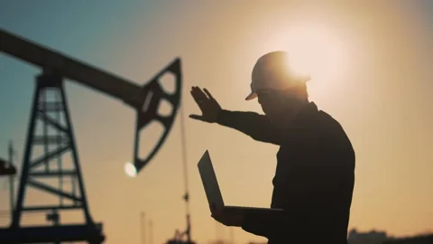 Oil pump.Engineer work with laptop and diagram.Checking operation of oil pump at Video stock 237146043