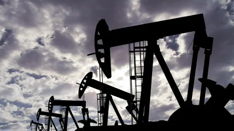 Oil Pumping Silhouettes with a Cloud Timelapse Stock Footage