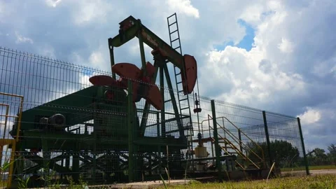 Oil pumpjack (nodding donkey)  in work. Oil industry in Seria, Brunei. Stock Footage 132188376