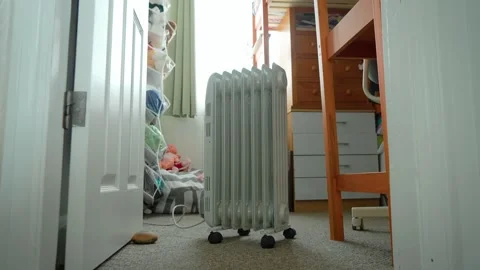 Oil radiator heater warming small bedroom during winter season. Portable Видео 337640895