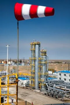 Oil refinery and gas processing columns (distillation towers) and weather vane. Stock Photos