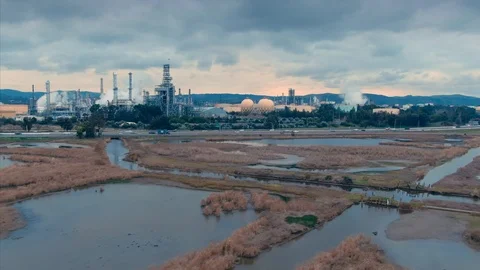 Oil Refinery behind a marsh under a cloudy sky.  Martinez, USA Stock Footage 101308514