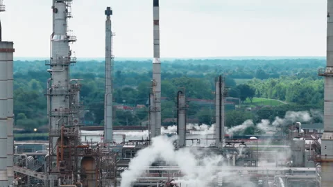 Oil Refinery Close Up: Distillation Columns Smokestacks and Rising Steam - Stock Footage 339379215