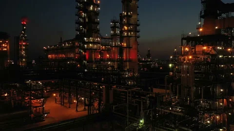 Oil refinery with illumination. Columns, reactors, pipes in color light. Evening Stock Footage 240084184