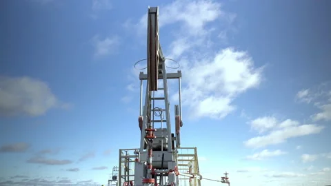 An oil rig extracts raw materials from the ground against the background of the Stock Footage 142519479