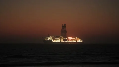 Oil Rig platform in Atlantic ocean glowing in evening sky Stock Footage 157583954