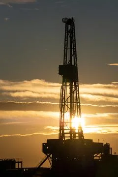 Oil rig at sunset Stock Photos