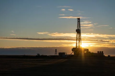 Oil rig at sunset Stock Photos
