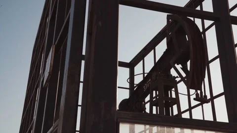 Oil rig is working, extracting oil.pumping unit and the silhouette of oilfi.. Stock Footage 232605953