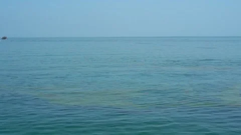 Oil slick on the calm ocean surface Stock Footage 303473465